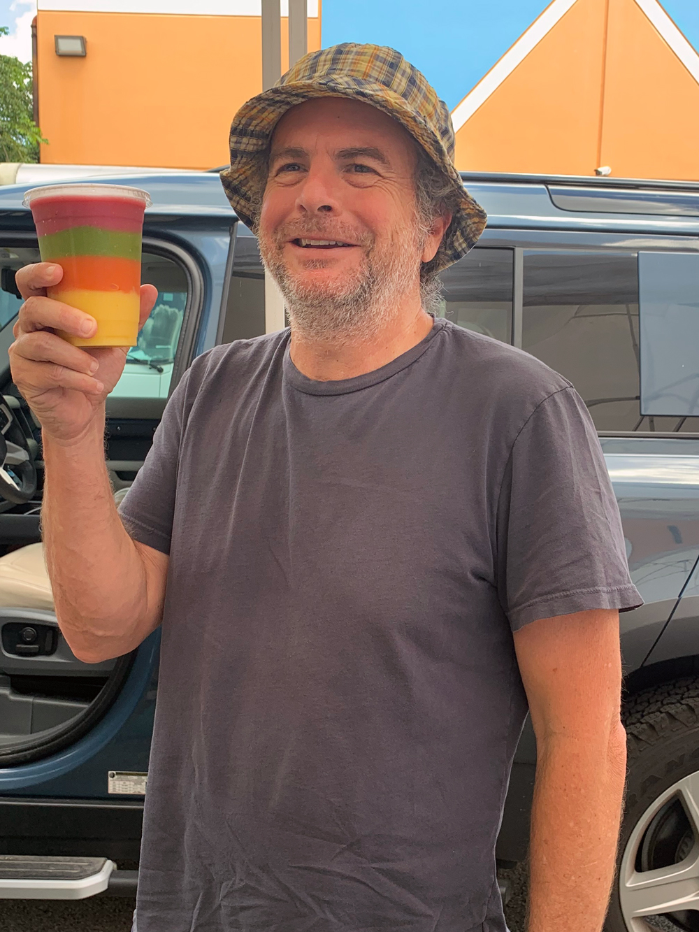 matt at drive through farmers market with a rainbow smoothie